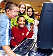 students gathered around a computer