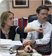 Staff members reviewing data on computer