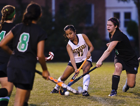 students playing field hockey