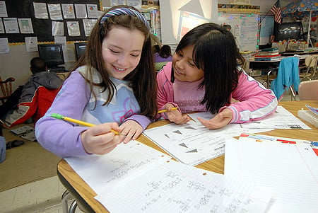 Middle school student holding up A+ paper (large)